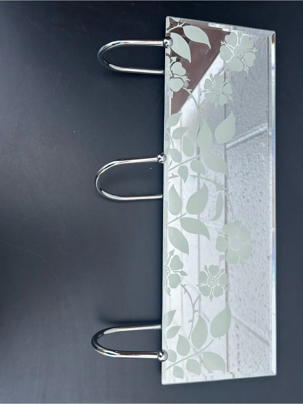 glass mirror coat rack featuring three chrome metal hooks and a delicate frosted